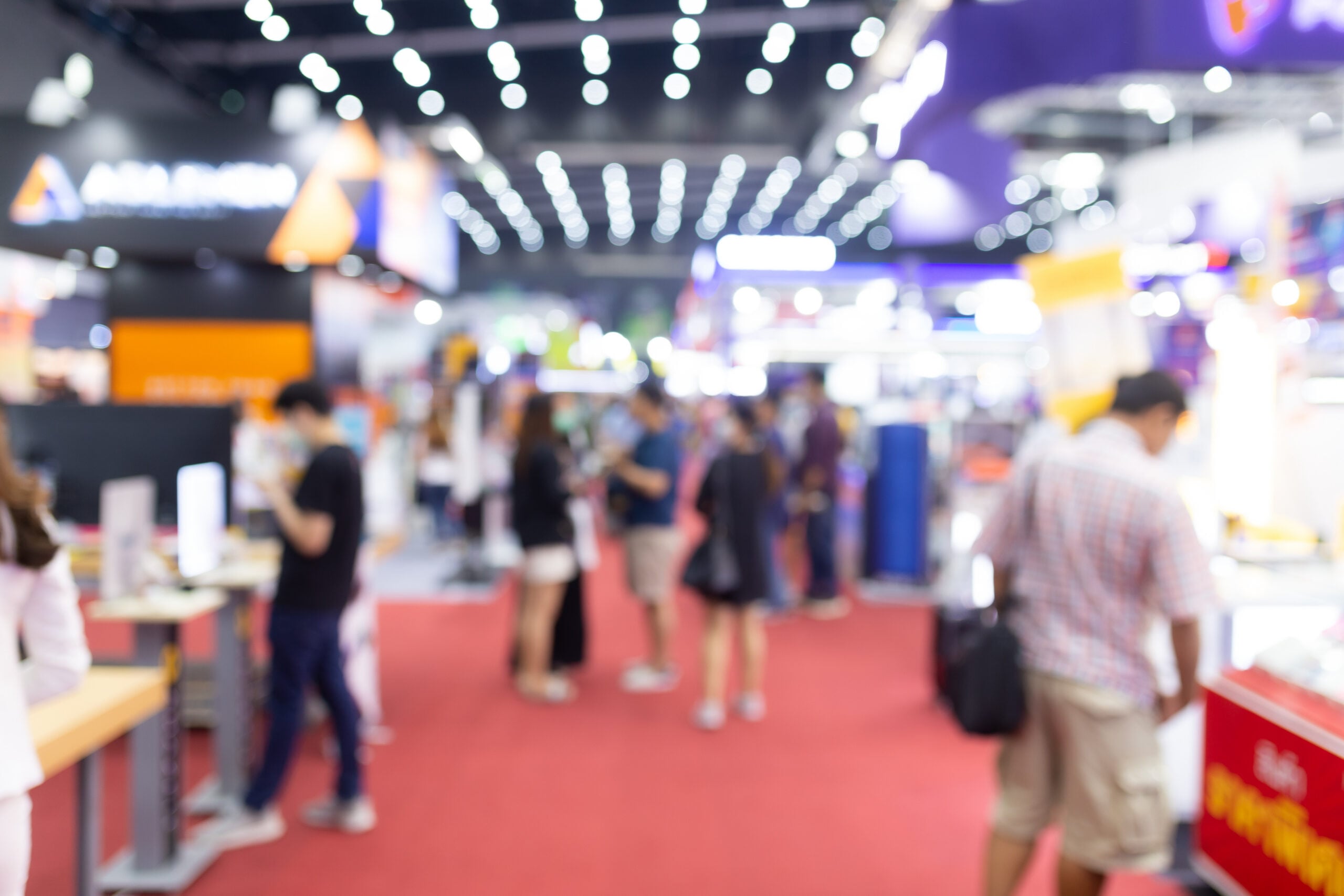 Abstract blur people in exhibition hall event trade show expo background. Business convention show, job fair, or stock market. Organization or company event, commercial trading, or shopping mall marketing advertisement concept